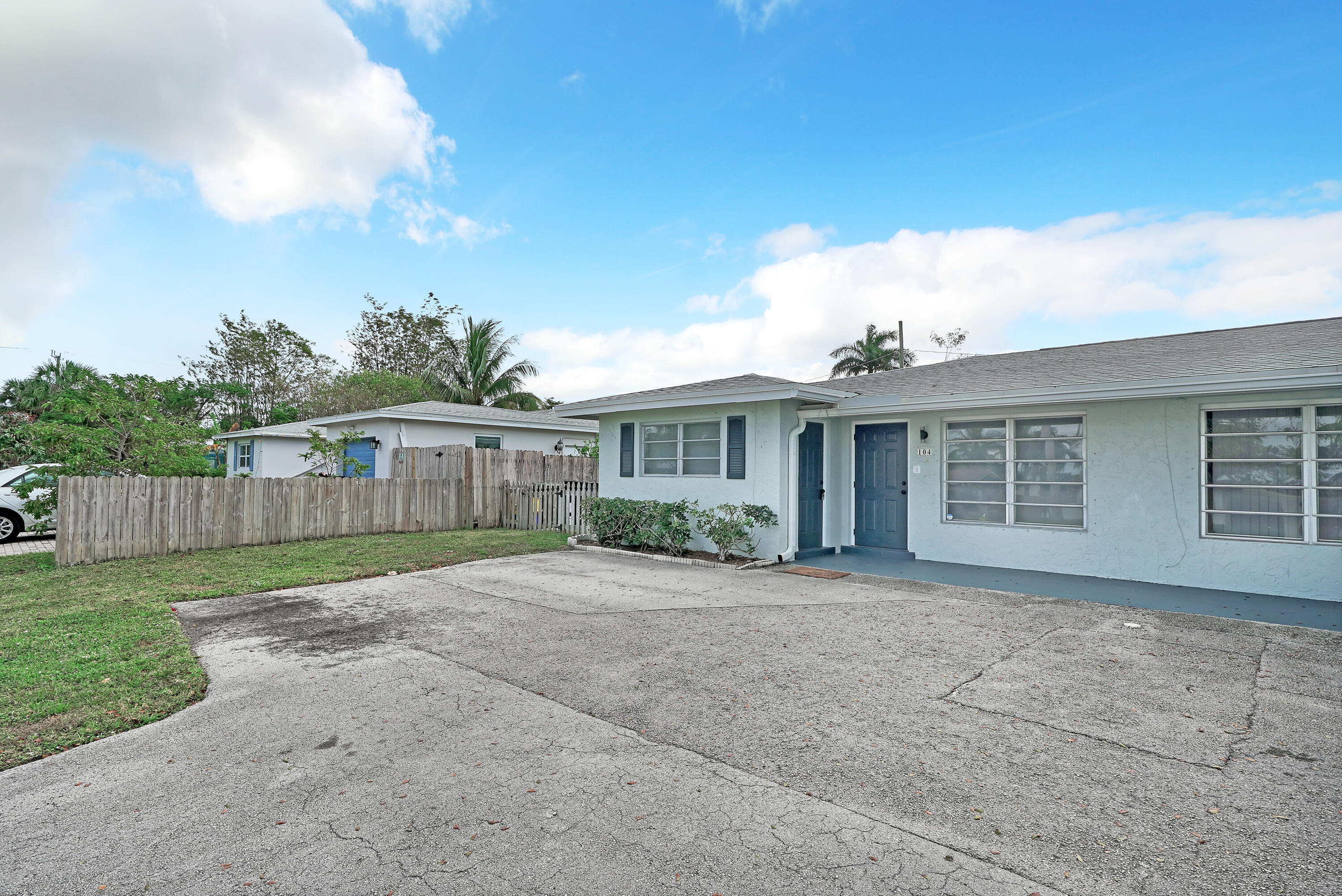 104 Palamino Circle Boca Raton, FL 33487 - Photo 28 of 34 a view of a house with a yard and potted plants