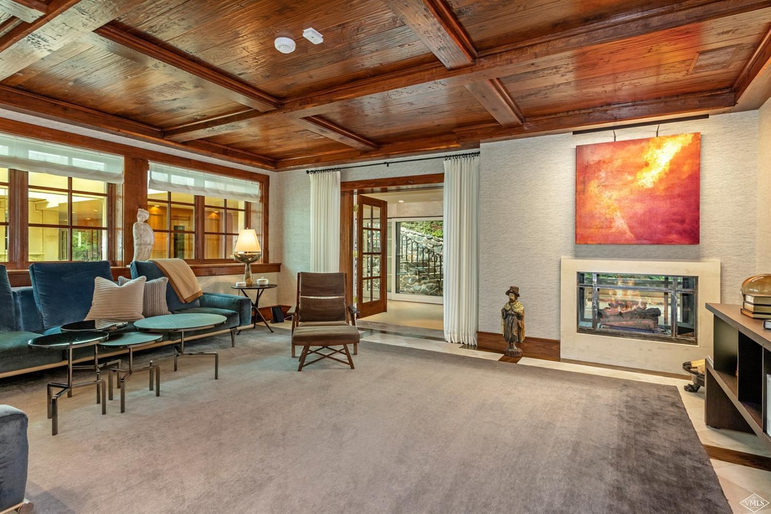 424 West Forest Road Vail, CO 81657 - Photo 7 of 17 a living room with furniture gym equipment and a fireplace