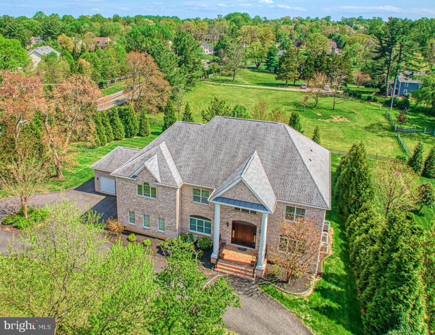 an aerial view of a house with a yard table and chairs
