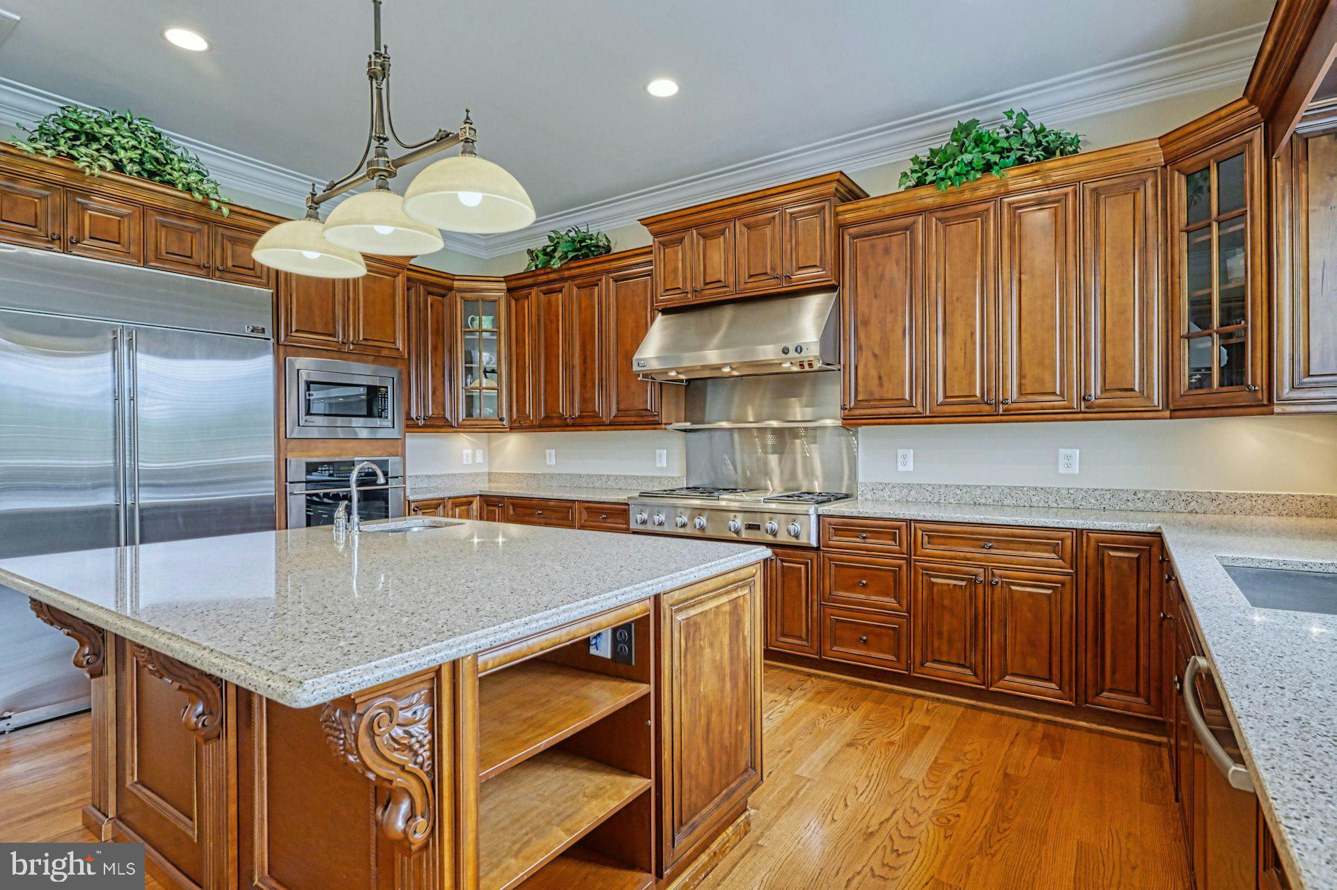 10405 Marbury Road Oakton, VA 22124 - Photo 12 of 72 a kitchen with stainless steel appliances granite countertop a sink a microwave cabinets and wooden floor