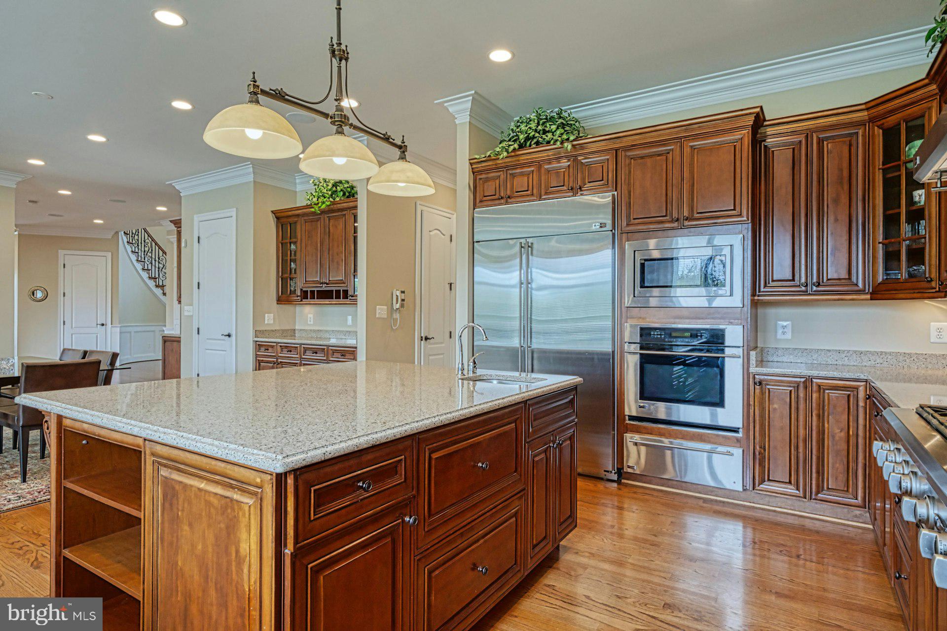 10405 Marbury Road Oakton, VA 22124 - Photo 13 of 72 a kitchen with stainless steel appliances granite countertop a sink a stove and a wooden cabinets