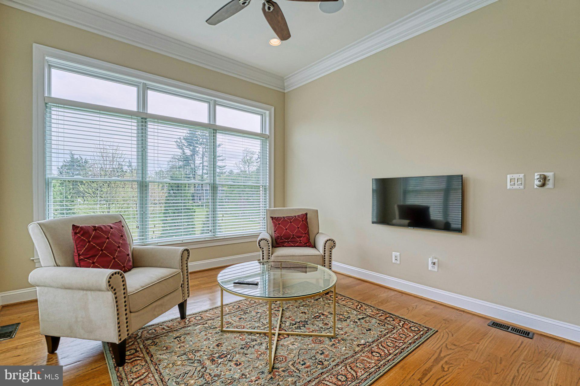10405 Marbury Road Oakton, VA 22124 - Photo 17 of 72 a living room with furniture a flat screen tv and a large window