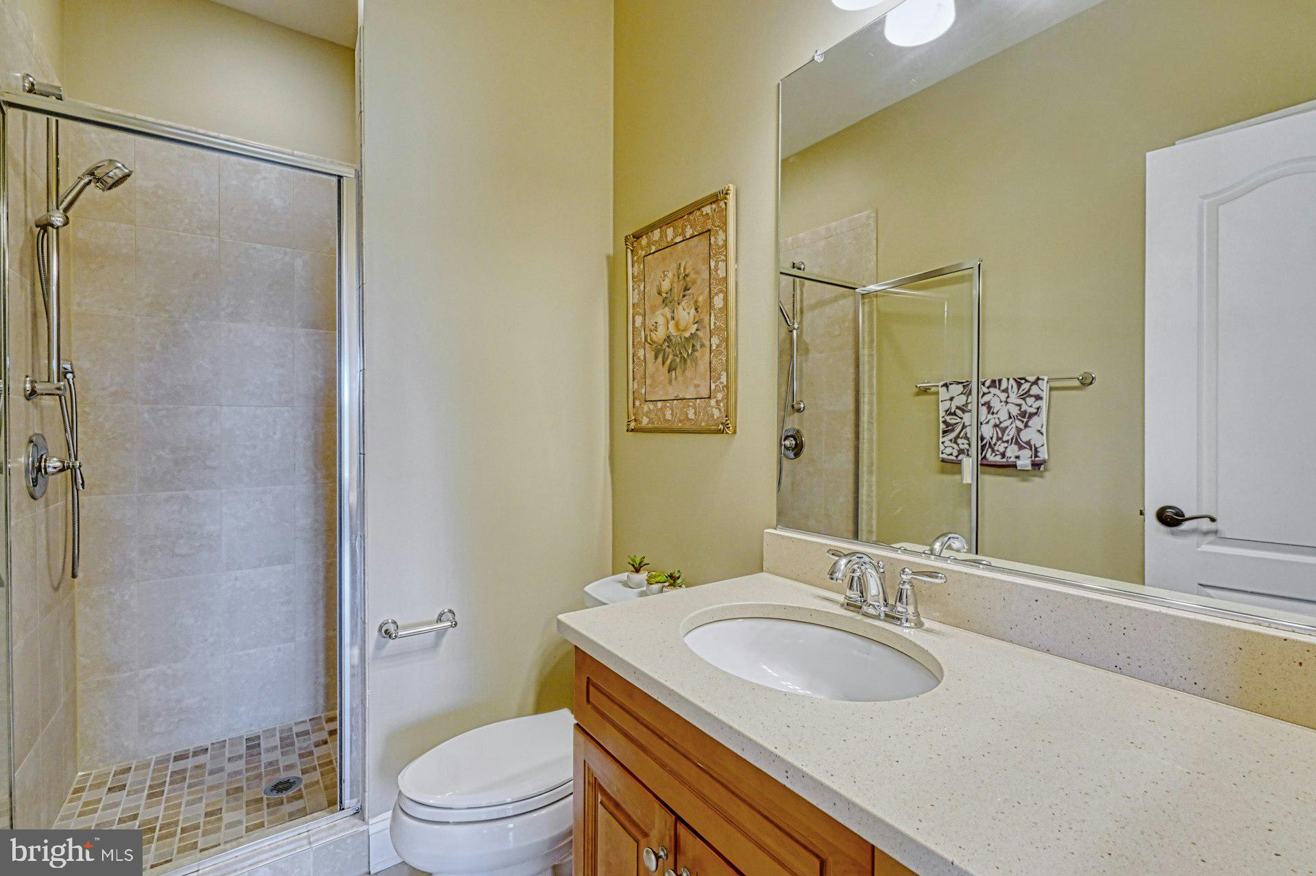 10405 Marbury Road Oakton, VA 22124 - Photo 43 of 72 a bathroom with a granite countertop sink toilet and shower
