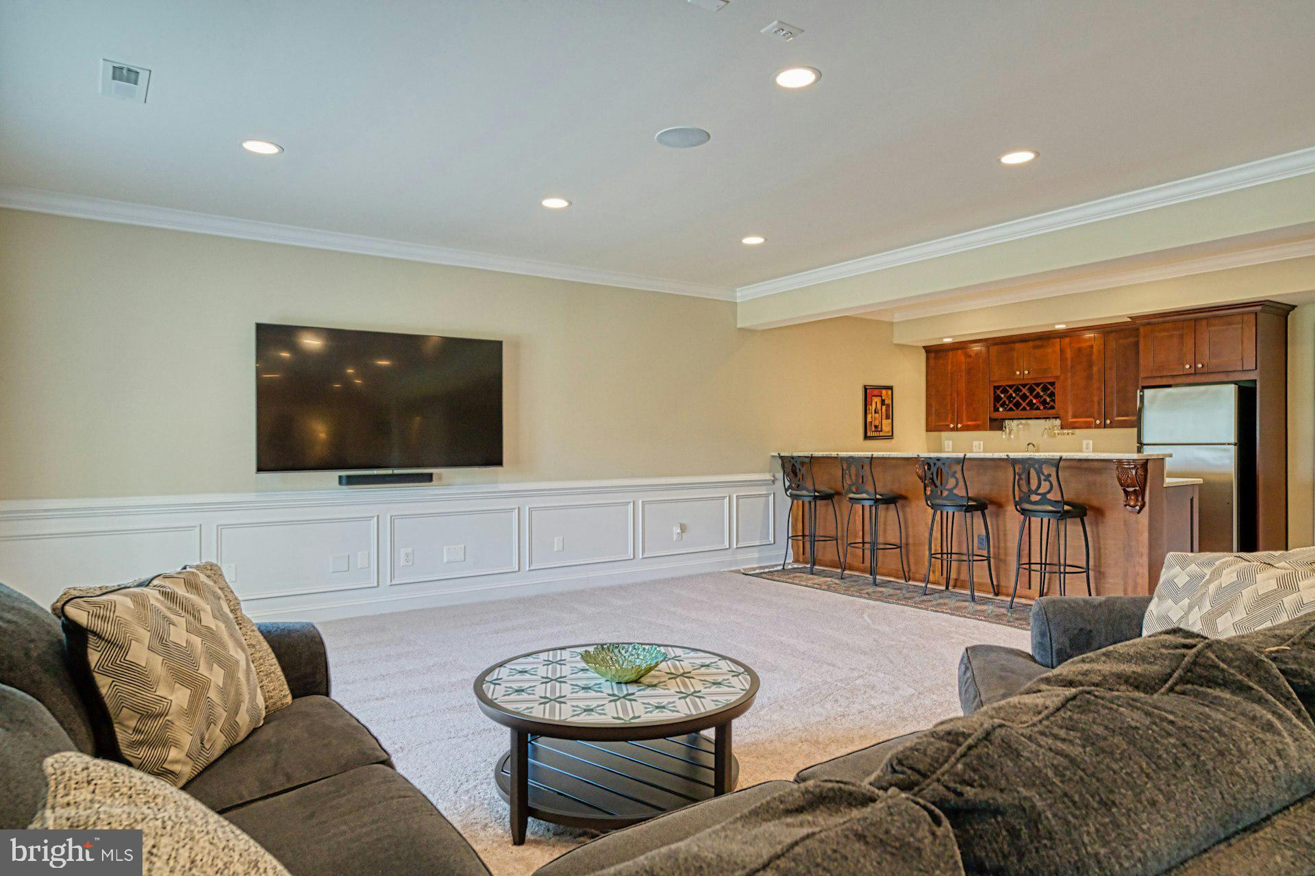 10405 Marbury Road Oakton, VA 22124 - Photo 50 of 72 a living room with furniture and a flat screen tv