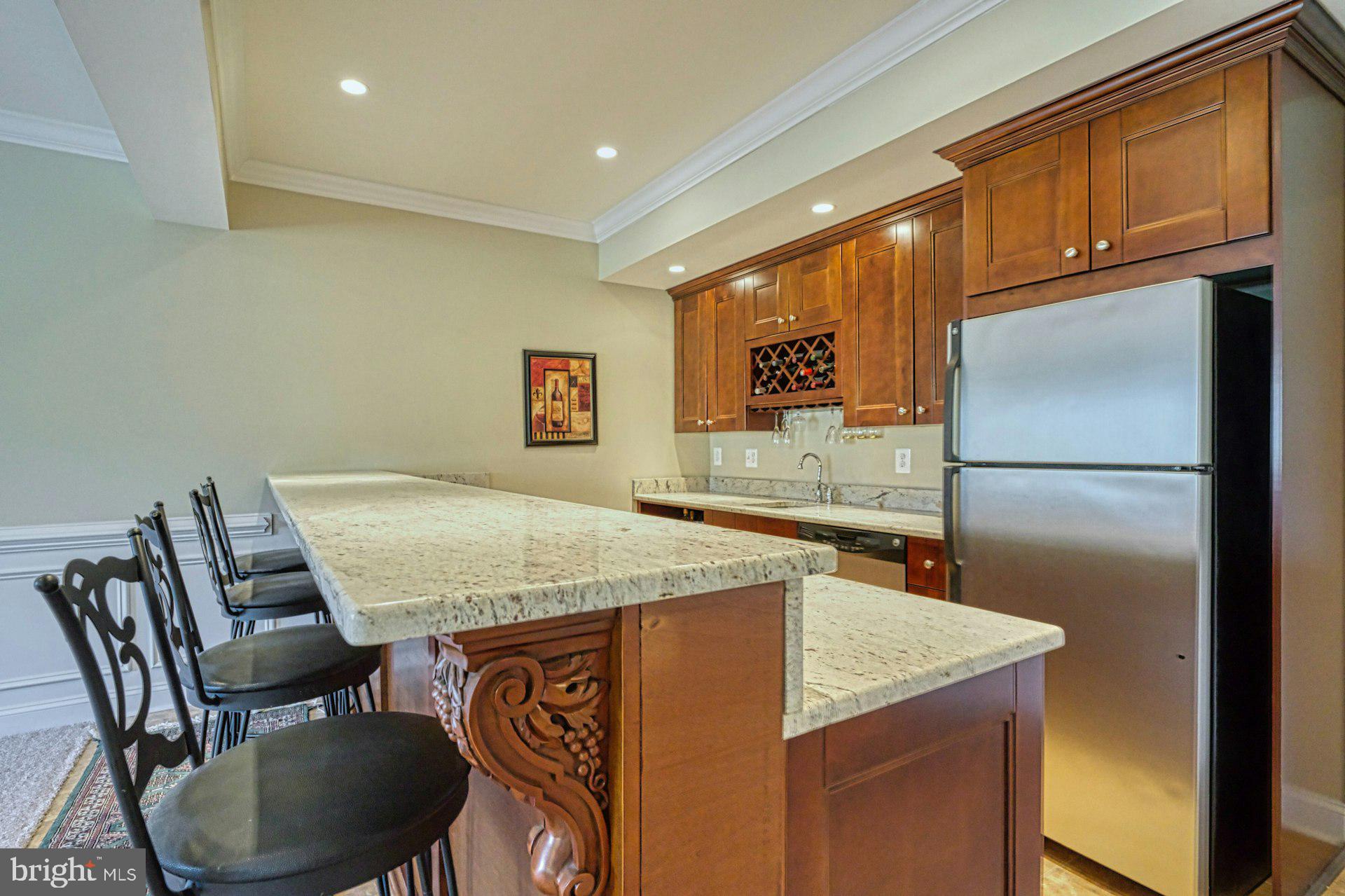 10405 Marbury Road Oakton, VA 22124 - Photo 52 of 72 a kitchen with stainless steel appliances granite countertop a table chairs refrigerator and sink