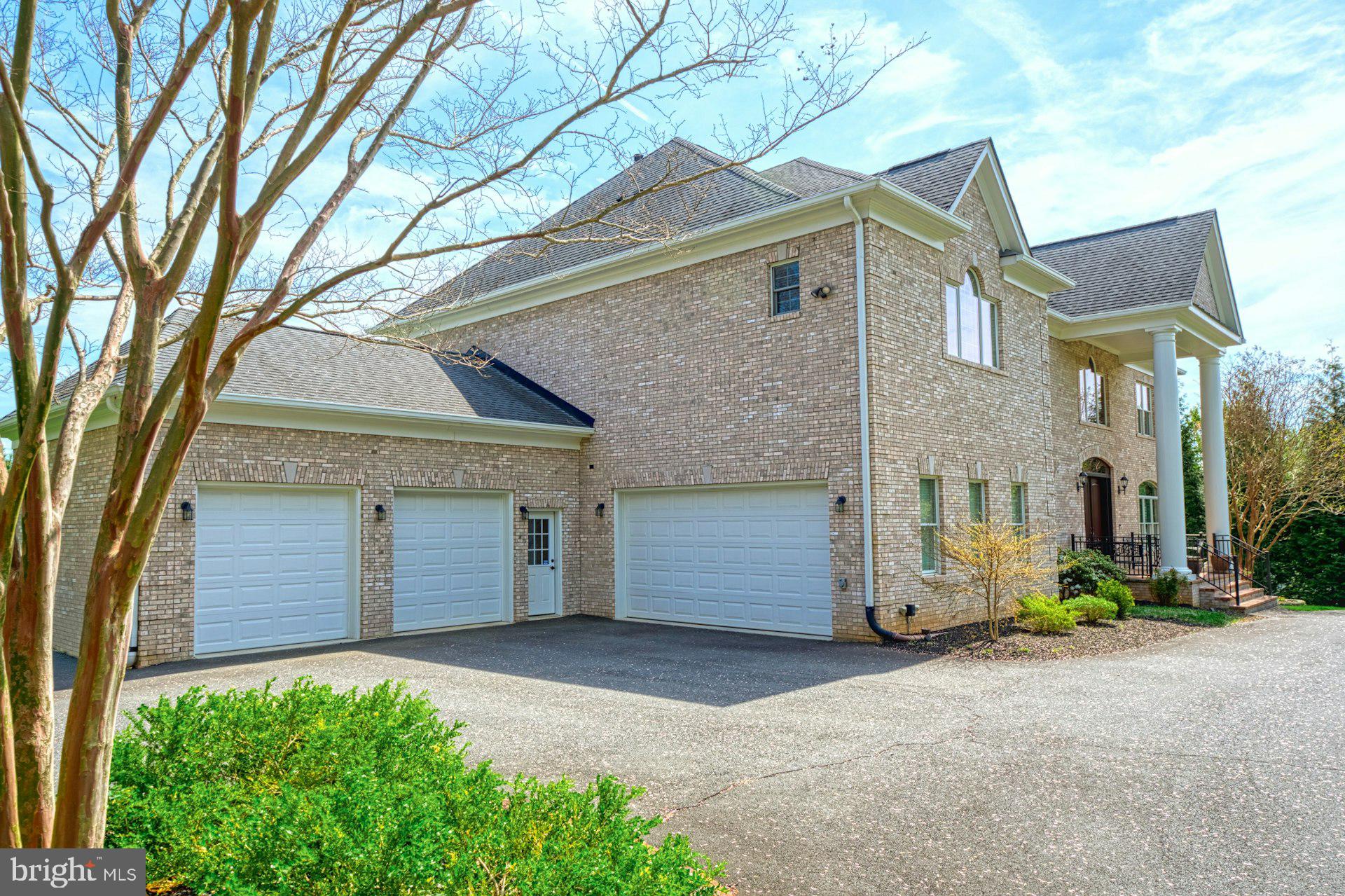 10405 Marbury Road Oakton, VA 22124 - Photo 64 of 72 a front view of a house with a yard and garage