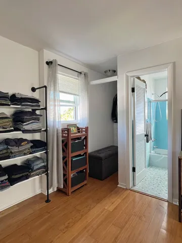 a view of room with furniture and wooden floor