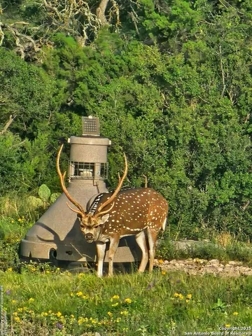 an aerial view of a house with garden space and sitting area