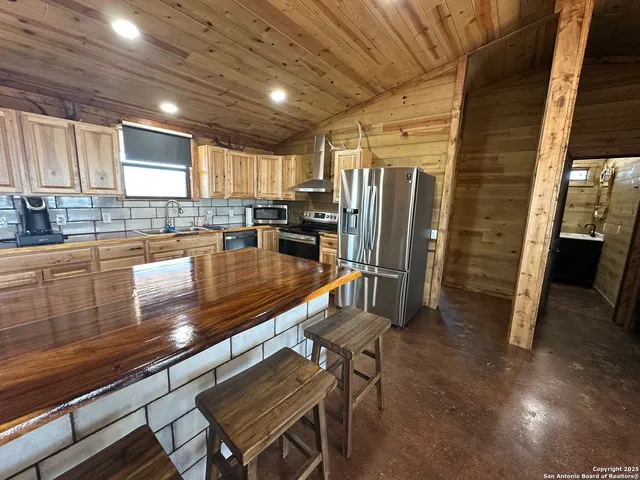 a view of a dry yard with trees