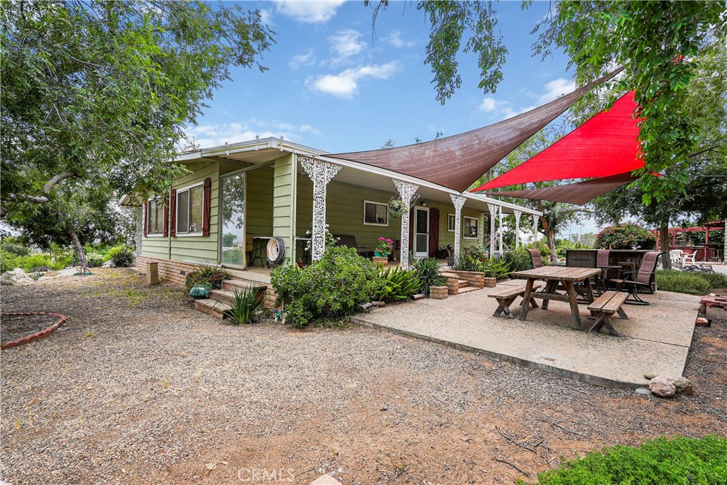 360 Shawnee Road Perris, CA 92570 - Photo 1 of 1 a view of a house with backyard sitting area and garden