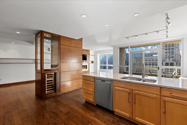 a kitchen with stainless steel appliances granite countertop a refrigerator and a sink