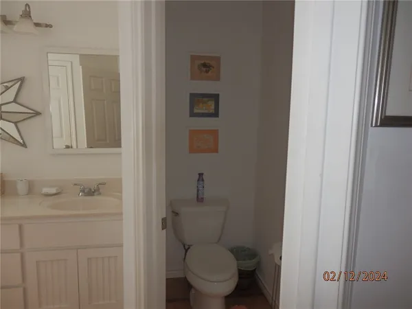 a bathroom with a granite countertop sink a toilet and a shower