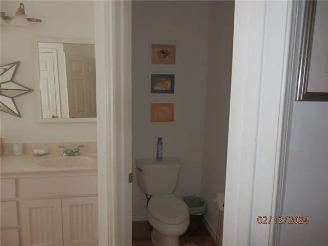 a bathroom with a granite countertop sink a toilet and a shower