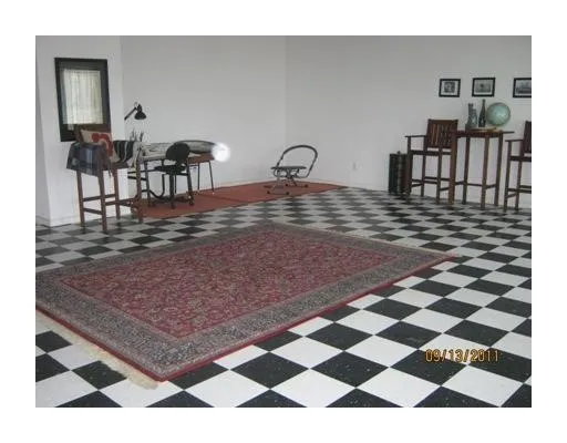 a view of a dining room with furniture wooden floor and next to a window