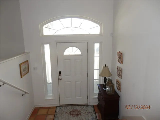 a view of an entryway with wooden floor