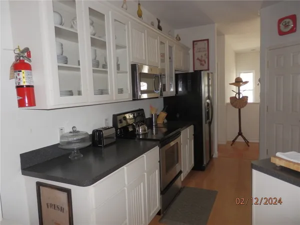 a kitchen with stainless steel appliances a sink stove and refrigerator