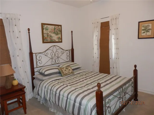 a bedroom with a bed and painting on the wall