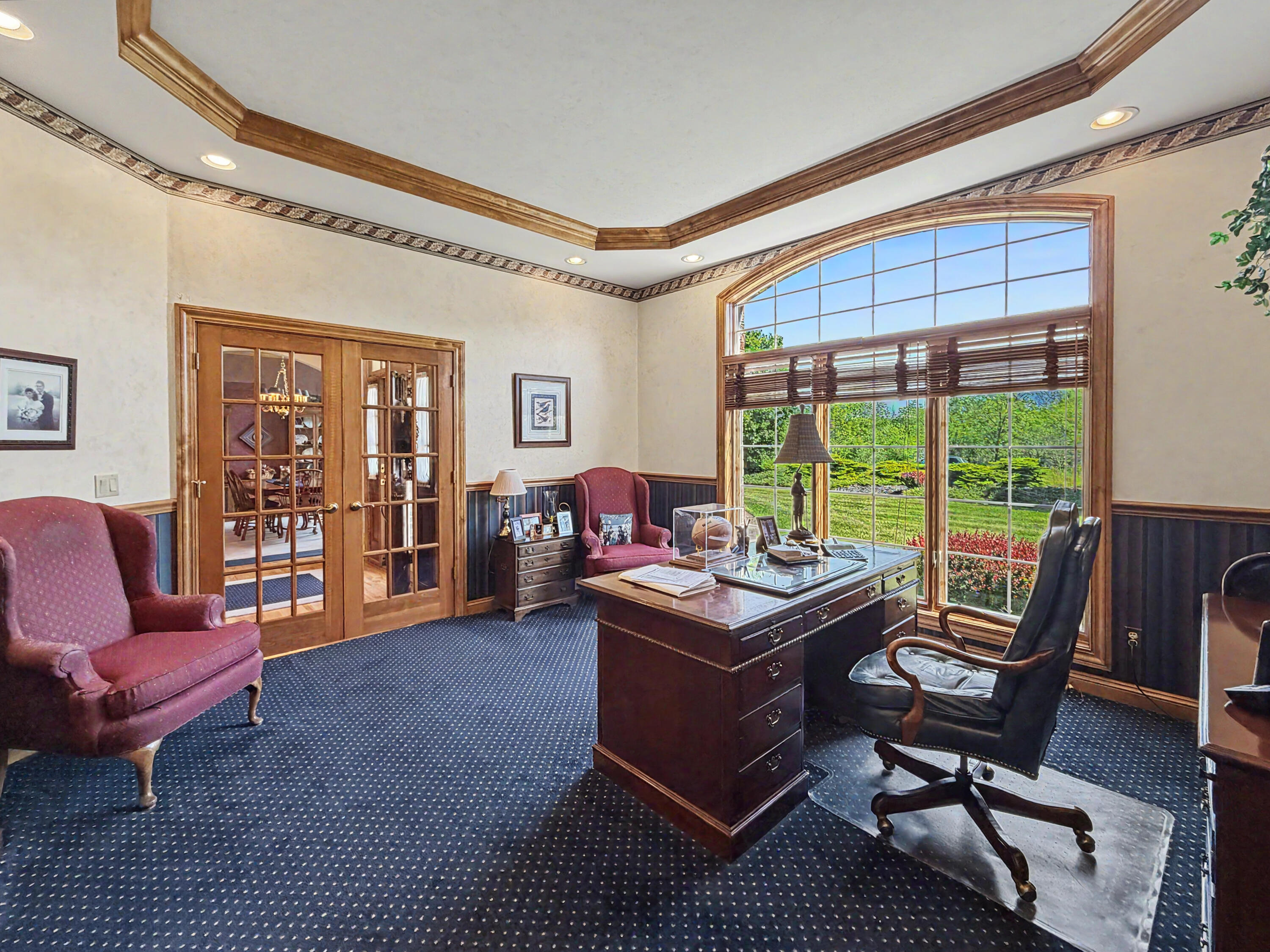 W291-s5245 Ridgefield Road Waukesha, WI 53189 - Photo 23 of 44 Beautiful main-floor third bedroom or optional office, highlighted by a tray ceiling, stunning arched window, French doors, and a spacious walk-in closet. This flexible space offers the perfect setting for a private office, library, guest suite, or additional bedroom.