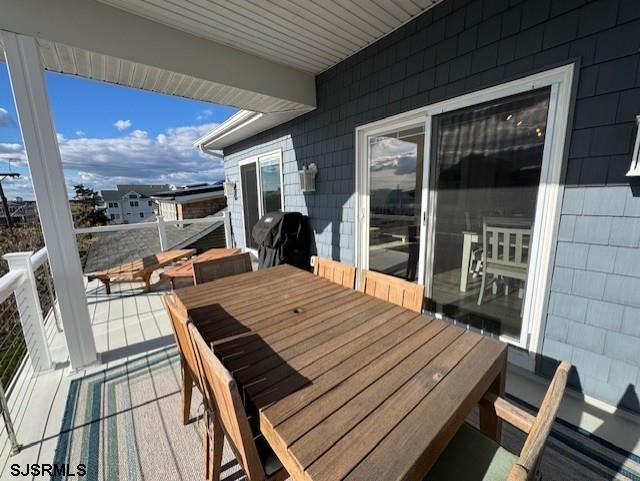 5 East Sumner Avenue Strathmere, NJ 08248 - Photo 24 of 31 a view of a patio with table and chairs with wooden floor and fence
