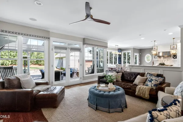 a view of a dining room with furniture large windows and wooden floor