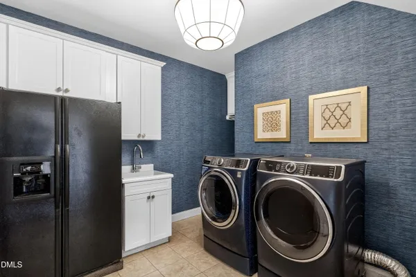a spacious en suite bathroom with a double vanity sink and a large mirror
