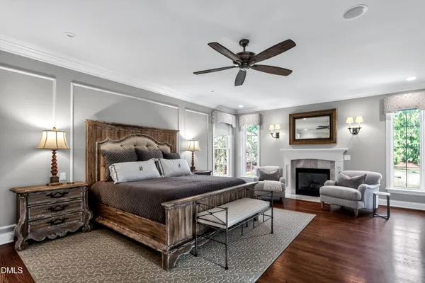 a view of a hallway with wooden floor and a potted plant