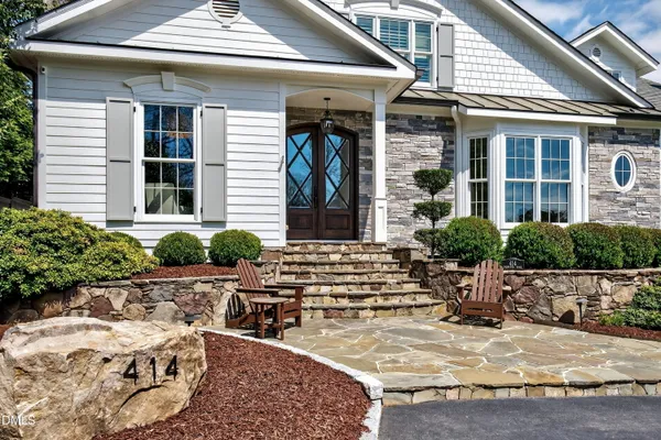 a living room with furniture and a book shelf