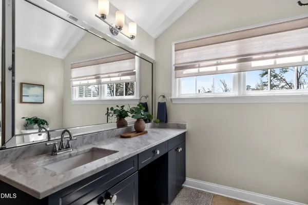 a view of a chairs and tables in the patio in front of a house
