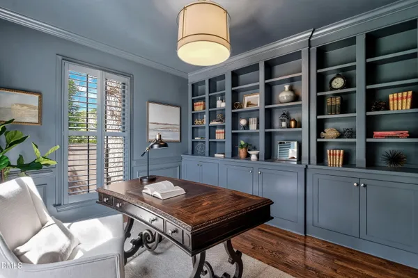 a view of a dining room with furniture wooden floor and chandelier