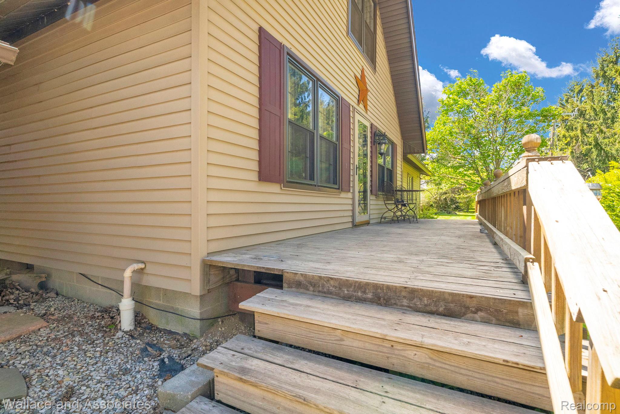 6616 Wellman Line Road Croswell, MI 48422 - Photo 13 of 47 View of home's exterior with a wooden deck