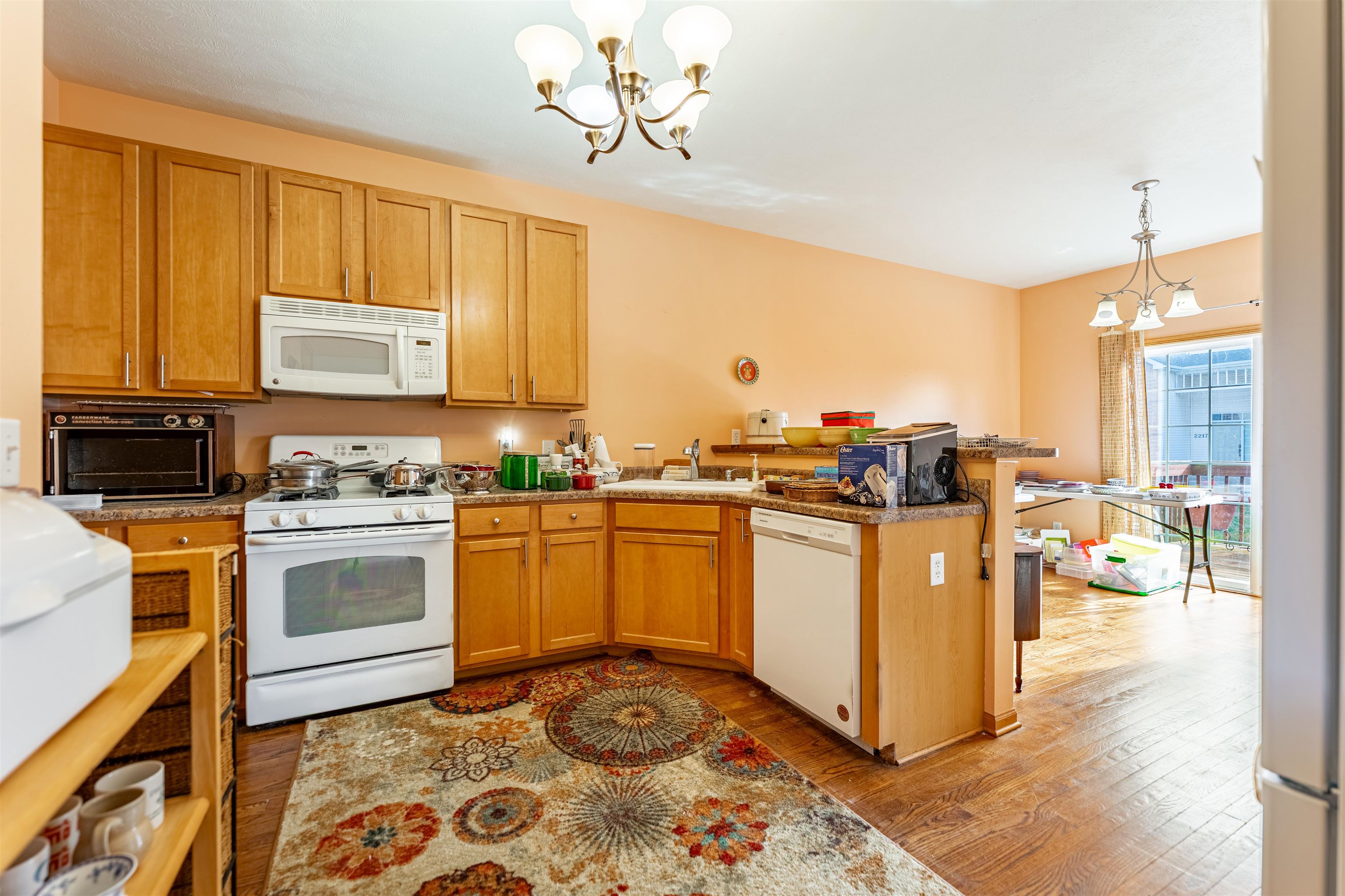 2155 Derby Lane Belvidere, IL 61008 - Photo 12 of 37 a kitchen with stainless steel appliances granite countertop a stove top oven a sink a dining table and chairs with the cabinets