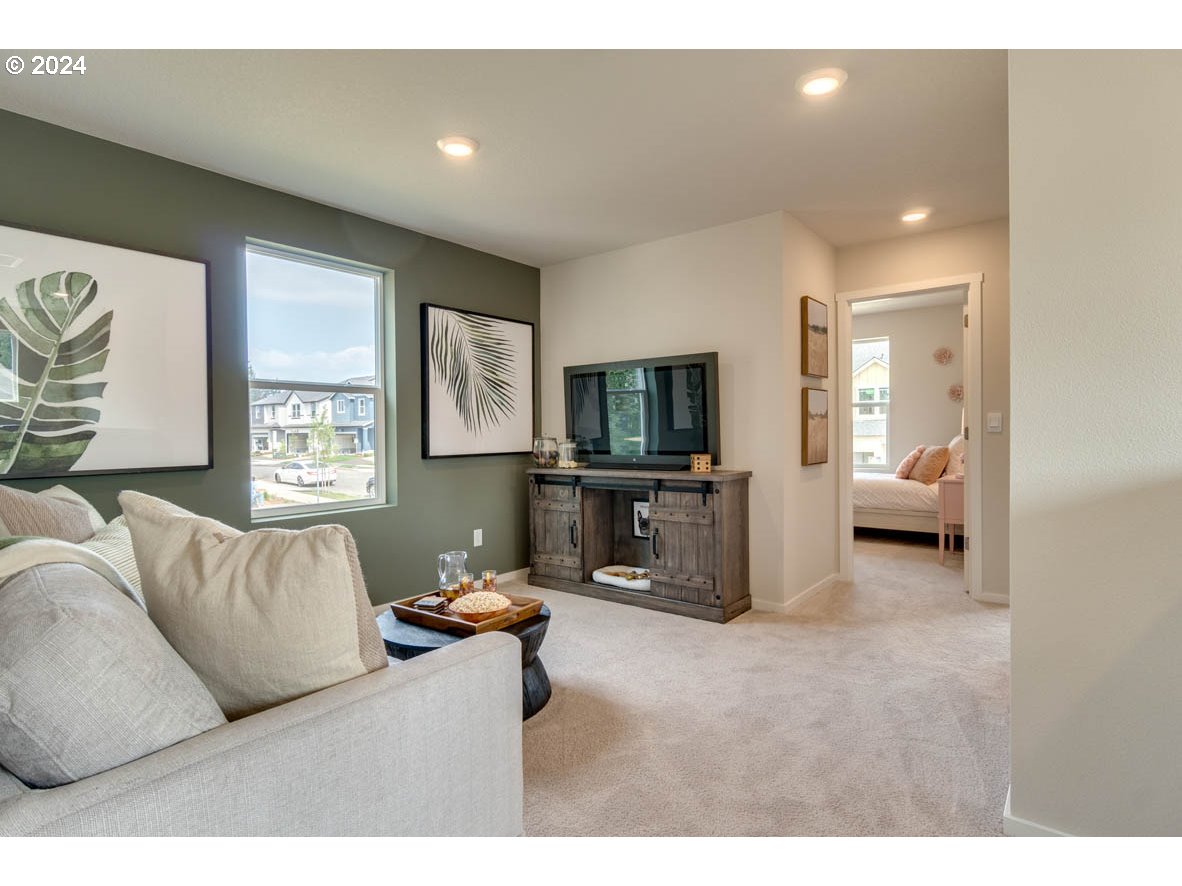 831 Northwest 175th Way Ridgefield, WA 98642 - Photo 7 of 21 a living room with furniture and a flat screen tv