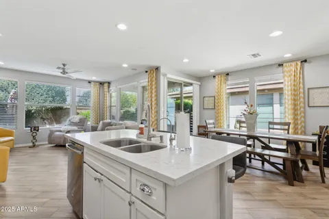 a kitchen with stainless steel appliances a stove and white cabinets