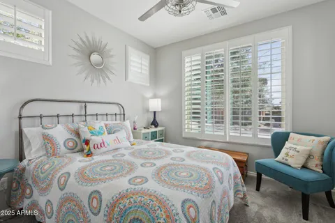 a bedroom with a bed and a large window