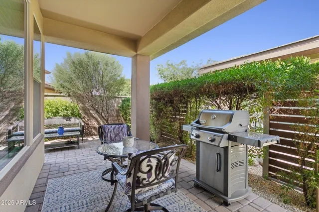 a backyard of a house with table and chairs