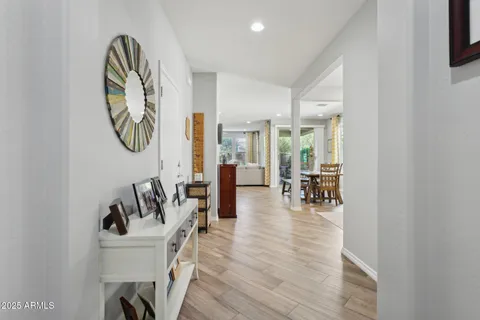 a large white kitchen with lots of counter space a sink refrigerator and cabinets