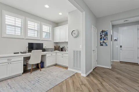 a living room with furniture a wooden floor and a large window