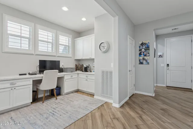 a living room with furniture a wooden floor and a large window