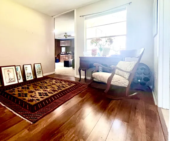a bedroom with furniture and a wooden floor