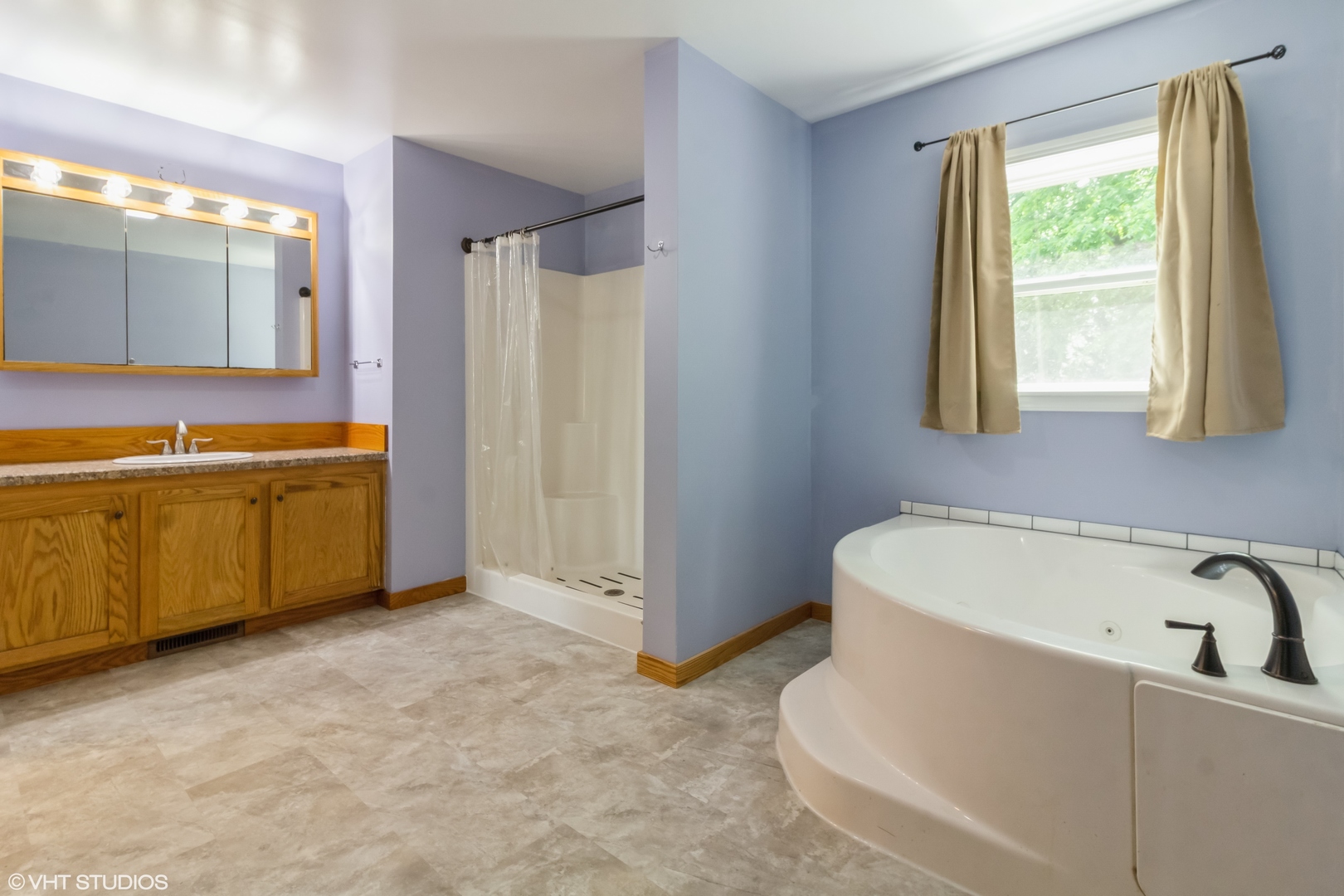 32597 Genoa Road Genoa, IL 60135 - Photo 12 of 31 a bathroom with a tub a sink and a window