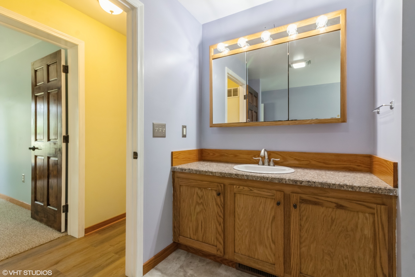32597 Genoa Road Genoa, IL 60135 - Photo 14 of 31 a bathroom with a granite countertop sink and a mirror