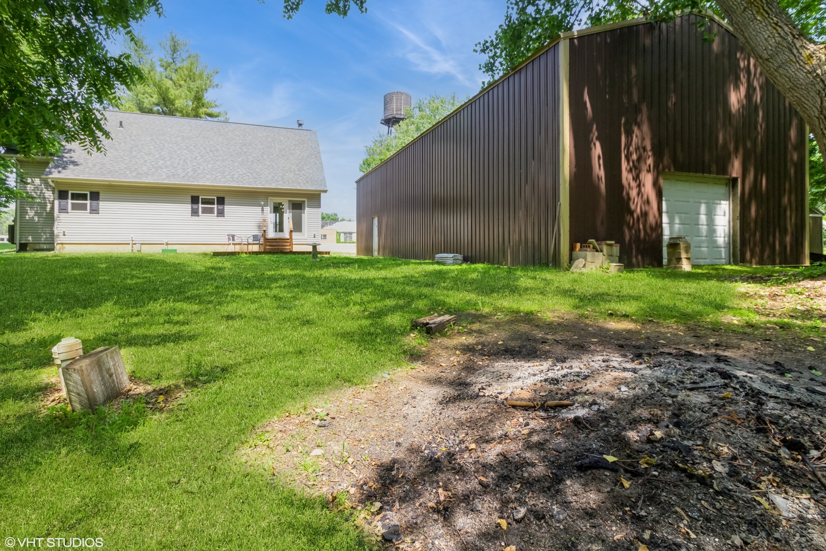 32597 Genoa Road Genoa, IL 60135 - Photo 23 of 31 a view of a house with backyard and a garden