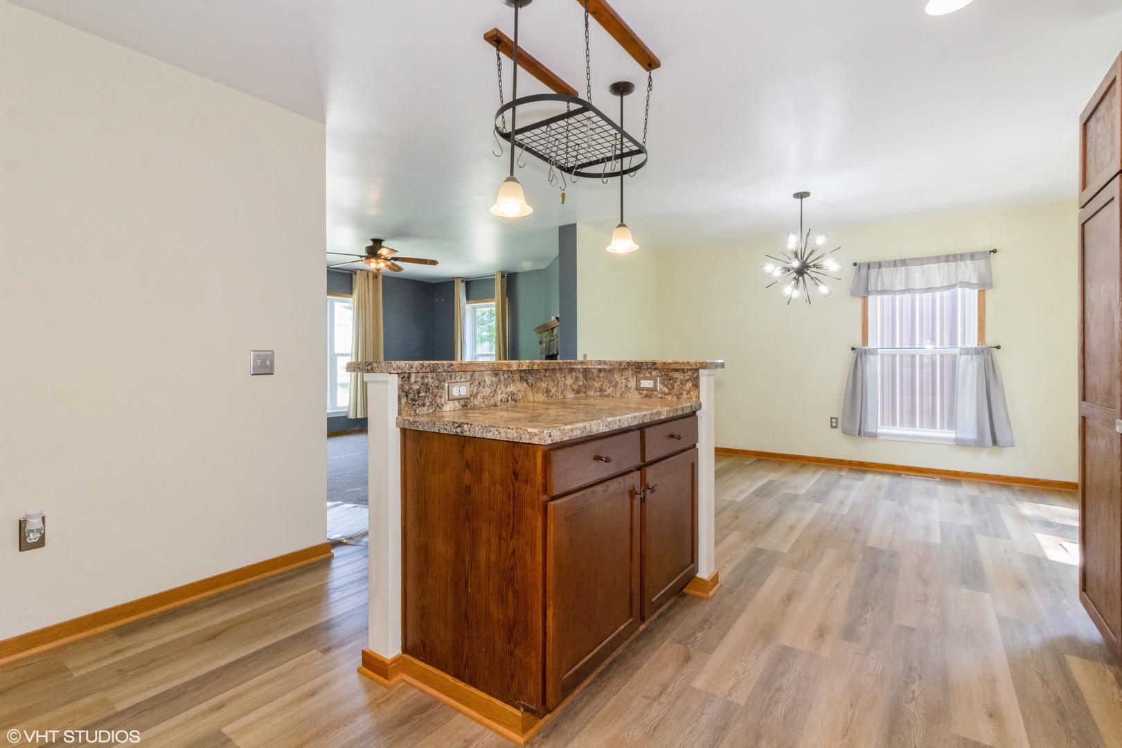 32597 Genoa Road Genoa, IL 60135 - Photo 7 of 31 a kitchen with stainless steel appliances granite countertop wooden floors and chandelier