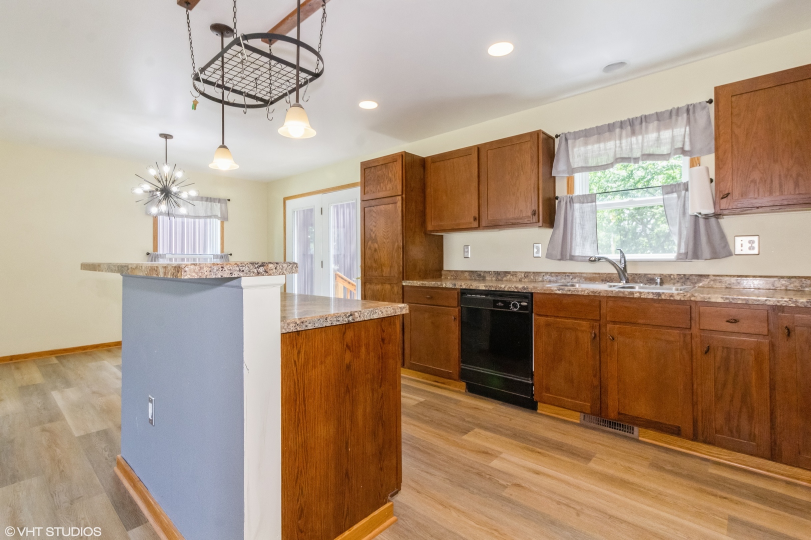 32597 Genoa Road Genoa, IL 60135 - Photo 8 of 31 a kitchen with stainless steel appliances granite countertop a sink a stove a refrigerator cabinets and wooden floor