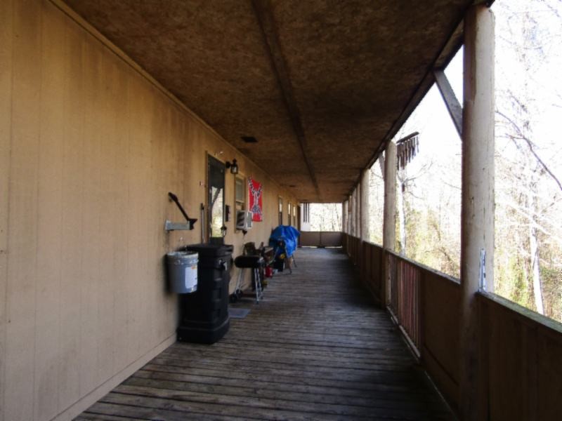 182 Ridge View Lane Baxter, TN 38544 - Photo 3 of 26 a view of a porch with wooden floor and outdoor seating