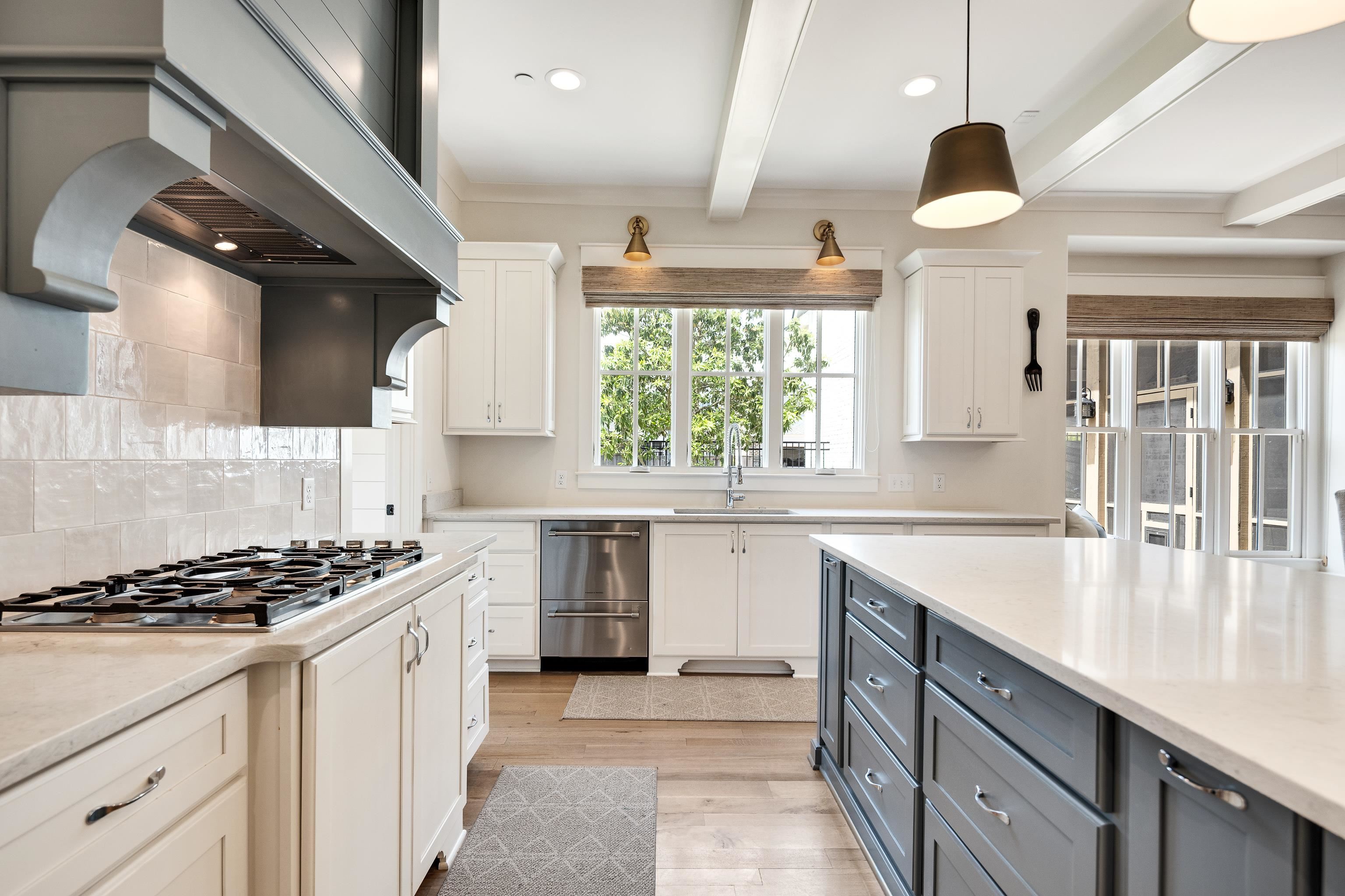 100 Sunflower View Road Piperton, TN 38017 - Photo 11 of 29 Gourmet kitchen featuring a gas range cooktop, custom range hood, white and gray cabinetry, stone countertops, and wood-finish flooring