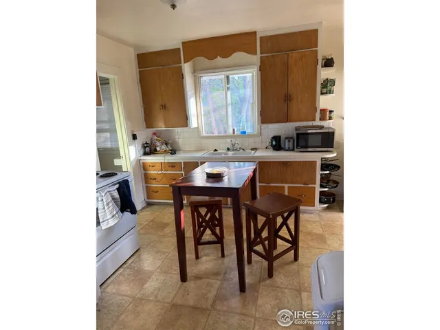 a kitchen with a table and chairs