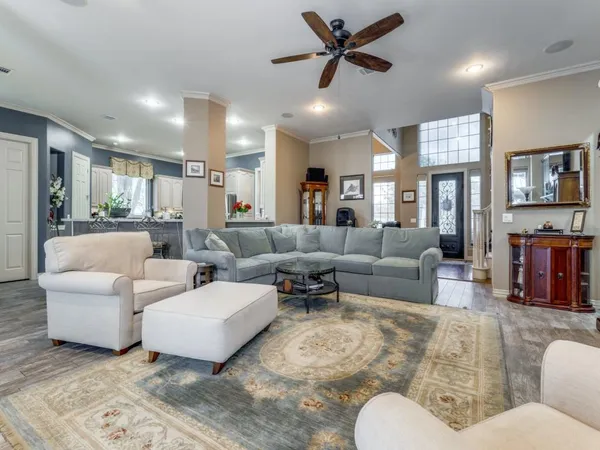 a living room with furniture and a large mirror