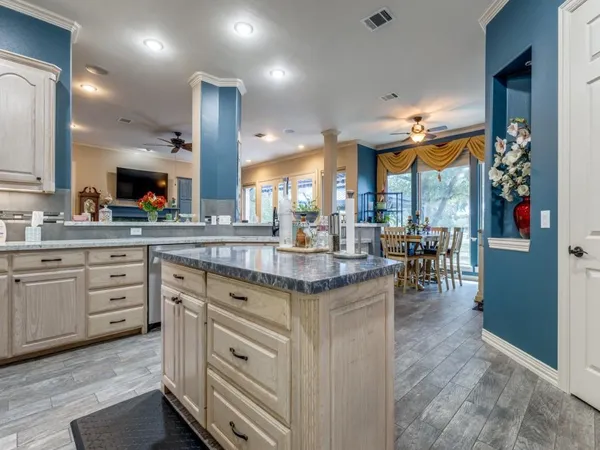 a kitchen with stainless steel appliances granite countertop a stove and cabinets