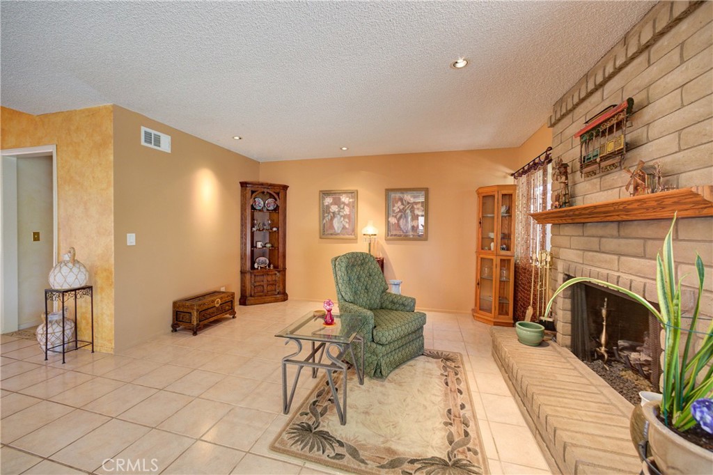 4185 Vanguard Drive Lompoc, CA 93436 - Photo 12 of 44 a living room with furniture a rug and a fireplace
